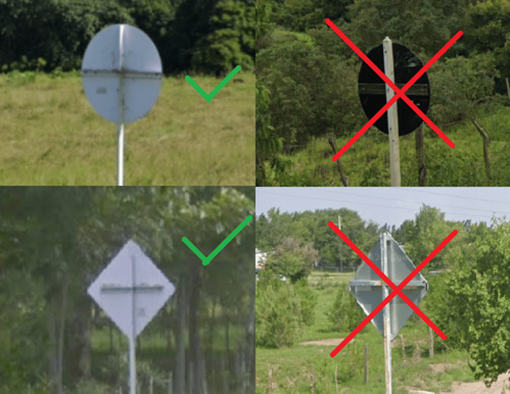 <p>White metal cross on back of signposts </p>