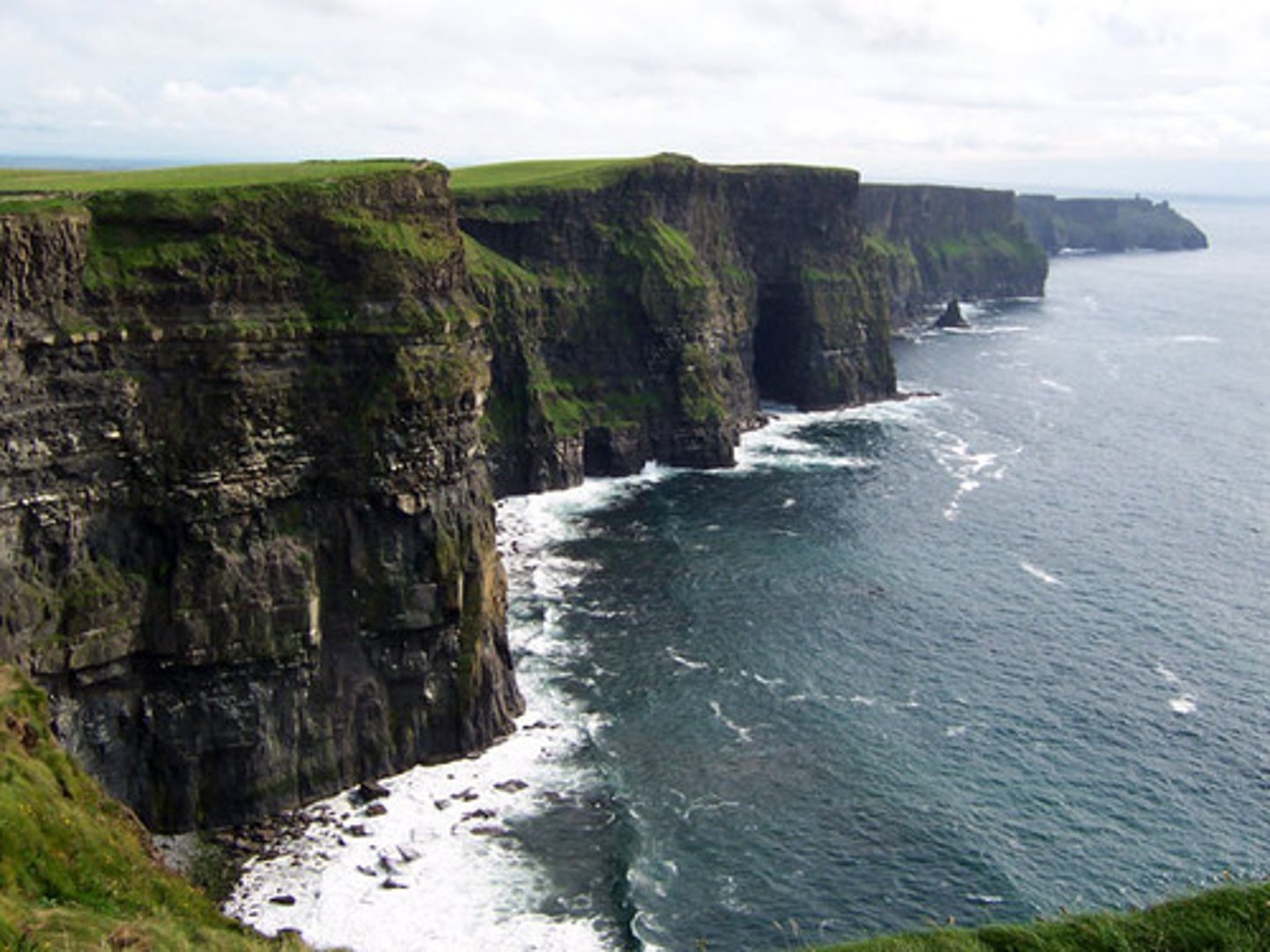 <p>A high, steep face of rock or earth</p>