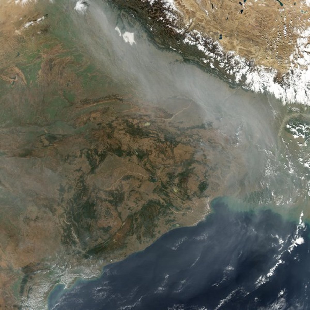 <p>huge dark brown cloud of industrial smog, caused by coal-burning in countries such as China and India, stretches over much of Southeastern Asia.</p>