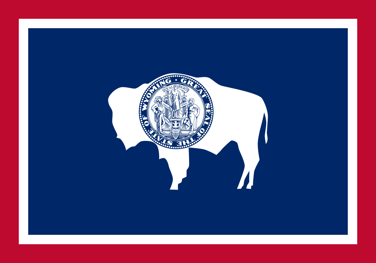 <p>Blue background with white and red outlines. White bison with emblem.</p>