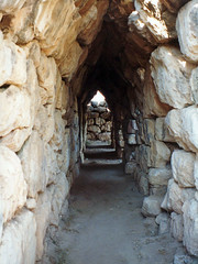 Stones piled in horizontal courses and then cantilevered inward until the two walls meet in a pointed arch