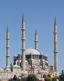 <p>a tower attached to a mosque. plays a tune/sound to call people to prayer five times a day</p>