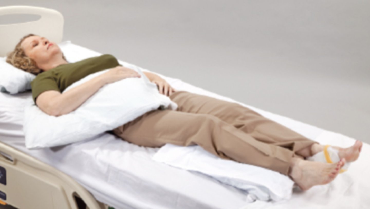 <p>Note the left heel protector, the support under the calves with suspension of the heels, and the neutral position of the glenohumeral joint achieved by raising the arm up off the mattress.</p>