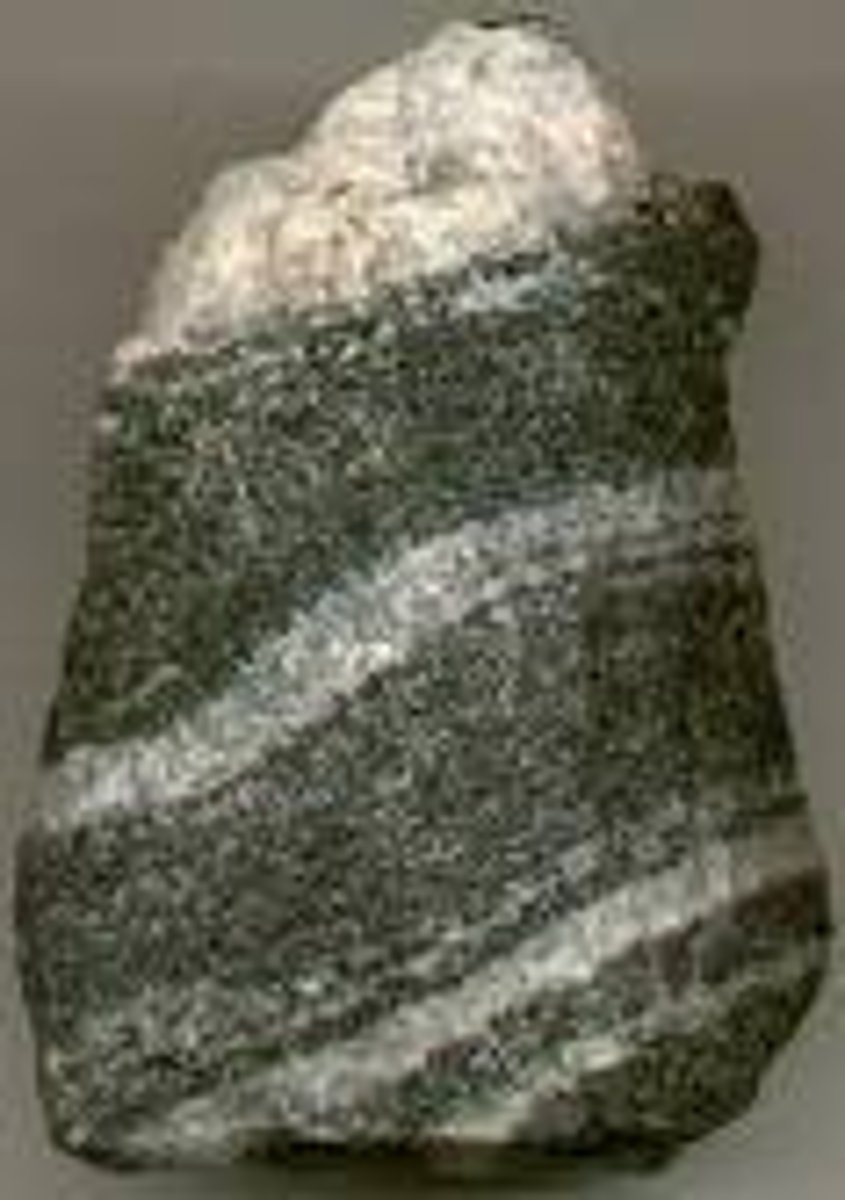 <p>- high temps &amp; pressure</p><p>- metamorphism</p><p>- new &amp; diff minerals b/c of chemical reactions with heated water/dissolved minerals</p><p>- foliated (leaflike) &amp; unfoliated</p><p>- foliated = compressed parallel bands of minerals (striped)</p><p>- slate, schist, gneiss = foliated/striped</p><p>- quartzite, marble (unfoliated/not banded)</p>