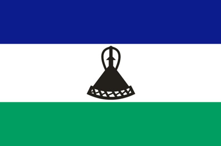 <p>Black mokorotlo = a Basotho hat.</p><p>Blue = the sky or rain.</p><p>White = peace.</p><p>Green = prosperity.</p><p>Represents a state that is both at peace internally and with its only neighbor South Africa.</p>