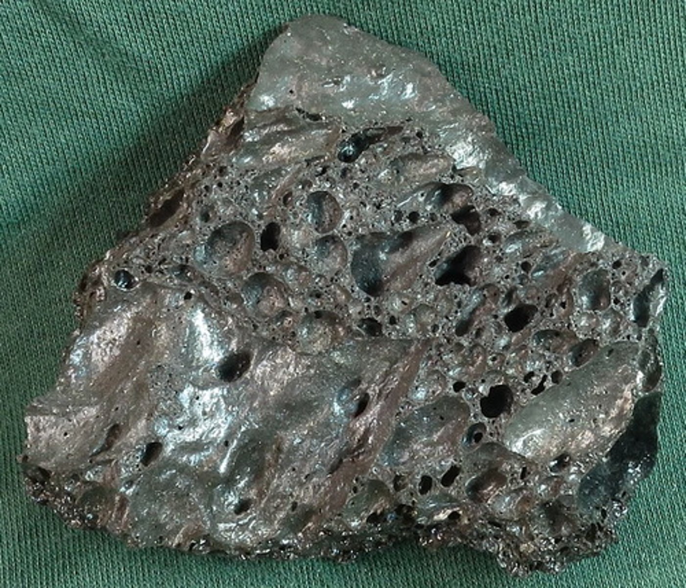 <p>This was foamy, molten rock when it was thrown into the air during an eruption. In the cold air it froze mostly to glass (volcanic rock - quickly-cooled, fine-grained or glassy)</p>