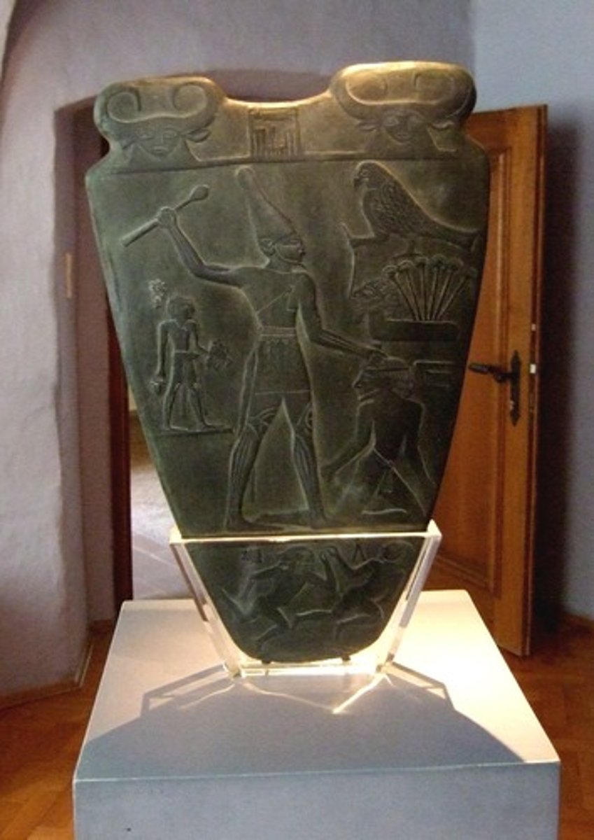 <p>- A carved ceremonial stone palette from c. 3100 BCE, depicting the unification of Egypt</p><p>- Shows Pharaoh Narmer wearing both the White Crown (Upper Egypt) and Red Crown (Lower Egypt)</p><p>- One of the earliest historical documents in the world, using proto-hieroglyphic symbols</p><p>- Follows Egyptian artistic conventions: figures shown in hierarchical scale, heads in profile</p><p>- Considered foundational for understanding early Egyptian kingship ideology</p>