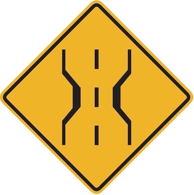 The bridge ahead is narrower than the roadway.