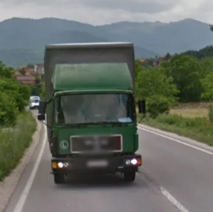<p>Green truck behind car</p>
