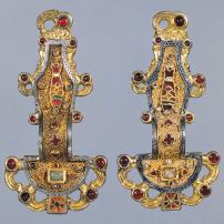 A decorative pin, usually used to fasten garments.