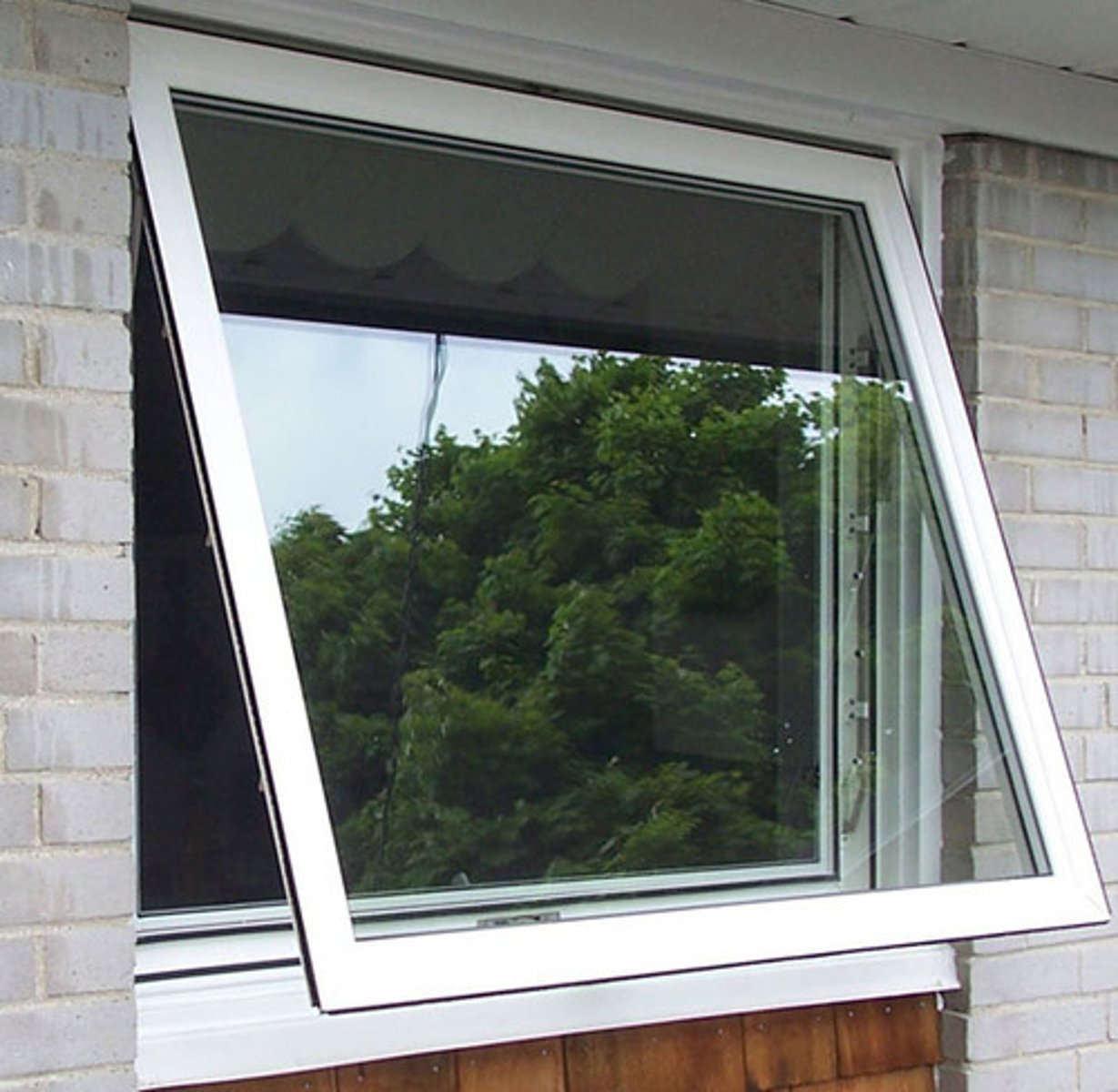 <p>A type of window having one or more sashes <span style="color: red"><strong>swinging outward </strong></span>on hinges, generally attached to the top of the frame.</p>