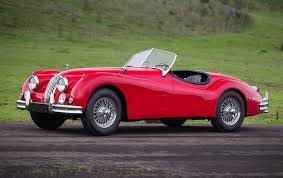<p>open two-seater=&gt;He drove an old open two-seater along the coast, the wind blowing through his hair.</p>