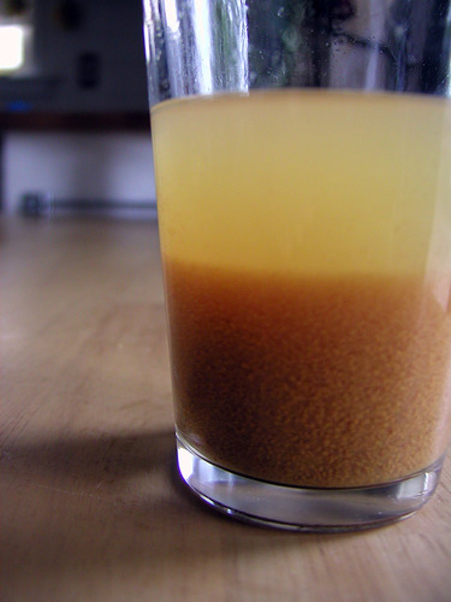 <p>a layer which forms on the bottom when added to a liquid</p>