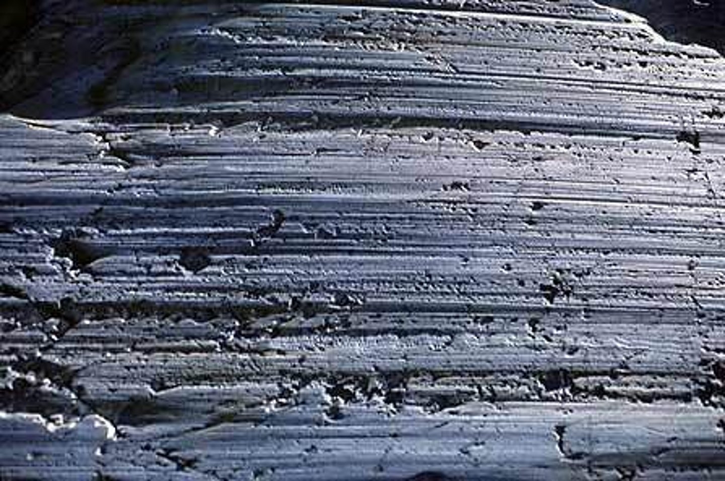 <p>Long parallel scars in rocks carved by rock fragments being dragged across them by a glacier (erosional)</p>