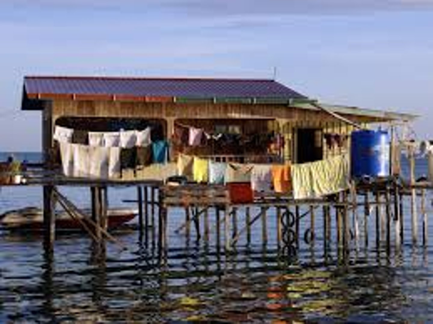 <p>a quiet village on the water with floating huts.</p>