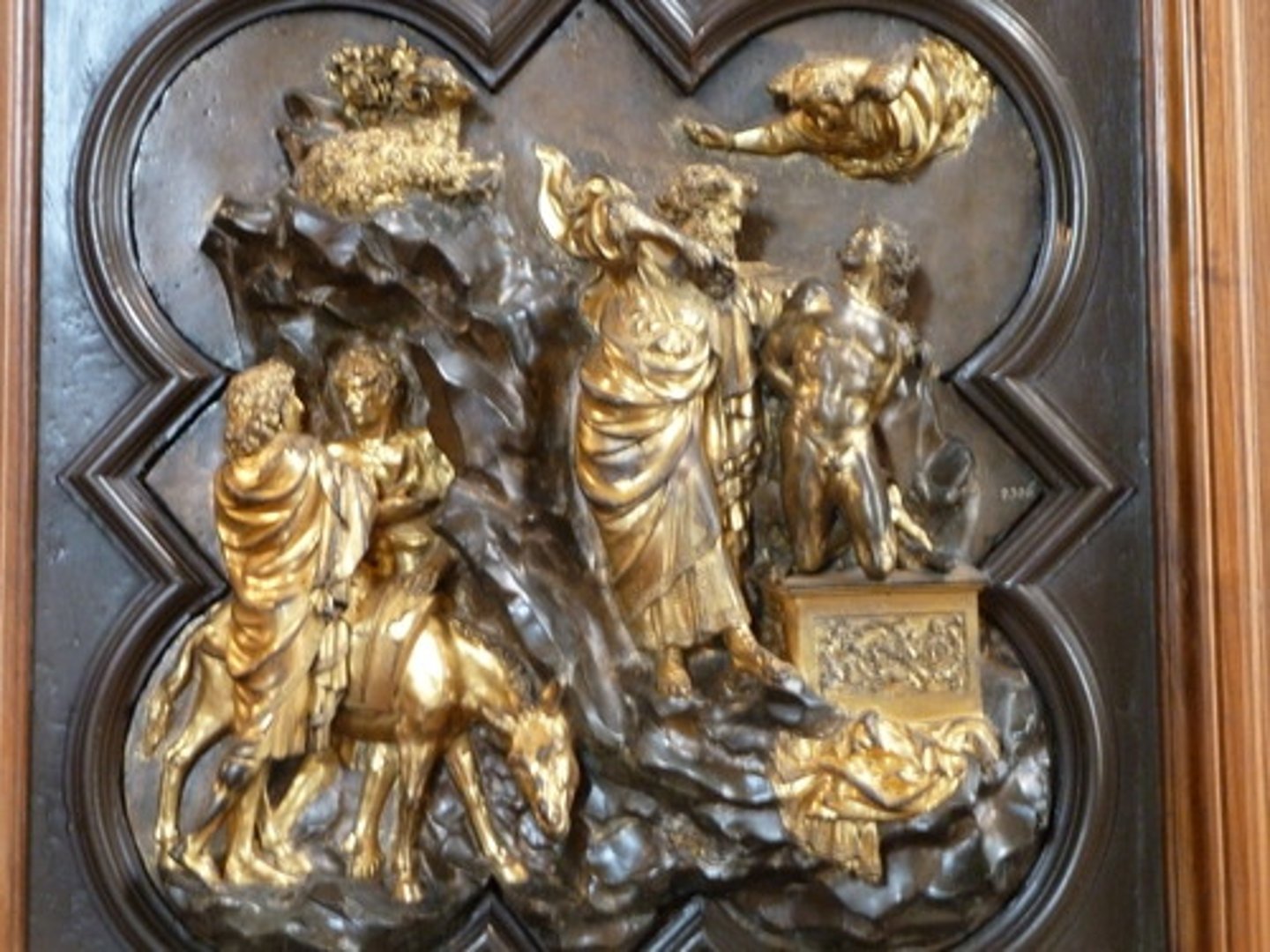 <p>One of the two only surviving entries from the competition, tells the story of God commanding Abraham to sacrifice his son, Isaac in a solitary place to test Abraham's faith. Eventually an angel appears and tells him to stop since he showed obedience to God. Out of the bushes a ram appears to take Isaac's place. Chose this story since Florence was being threatened by invaders from Milan and Florence's independence was threatened. Florentine officials asked people to defend the city, so they chose Isaac's story since it is about sacrificing to a higher cause and civic duty, which are both humanist virtues. Ghiberti's entry shows events not yet unfolded as the angel has not yet made it to Abraham. It showed more classicism (platform on which Isaac kneels is classic; the piece also had decoration of campus ? leaves often seen in Greco-Roman art; also Isaac's body is turned showing tension that has roots in classicism (see Epigonos' sculpture) and shows an emphasis on the skeletal structure of the figure with a muscular nude body). While showing classicism, it also has new ideas of Renaissance art. Isaac is fully nude which is new to the early Renaissance. The space looks more 3D (pictorial illusionism) and the angel is foreshortened showing projecting into space as the angel is moving towards the viewer. Also more landscape features included. Ghiberti ultimately won partially because since his was just cast in two pieces, reducing the amount of bronze needed, making it less expensive, lighter, and more resistant to the elements. Ghiberti becomes the leading sculptor of the time.</p>