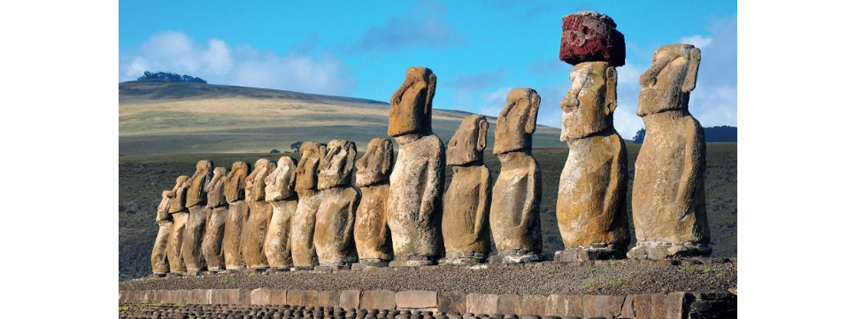 <p>Row of moai on a stone platform </p>