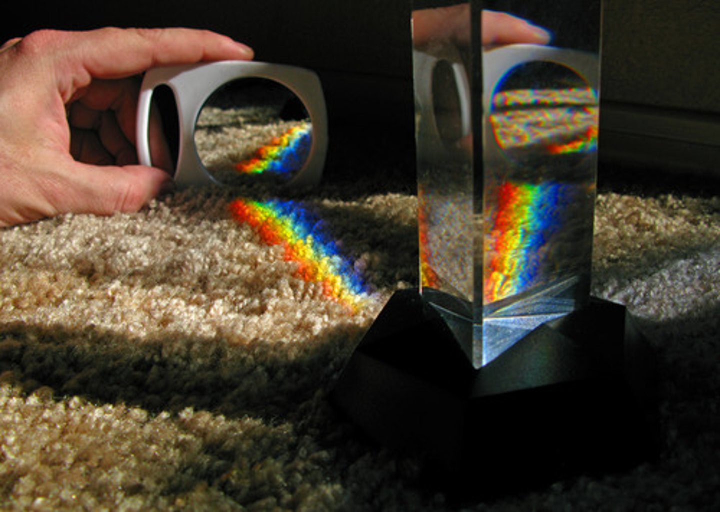 <p>A triangular piece of glass that refracts light into different angles, producing a spectrum of colors.</p>
