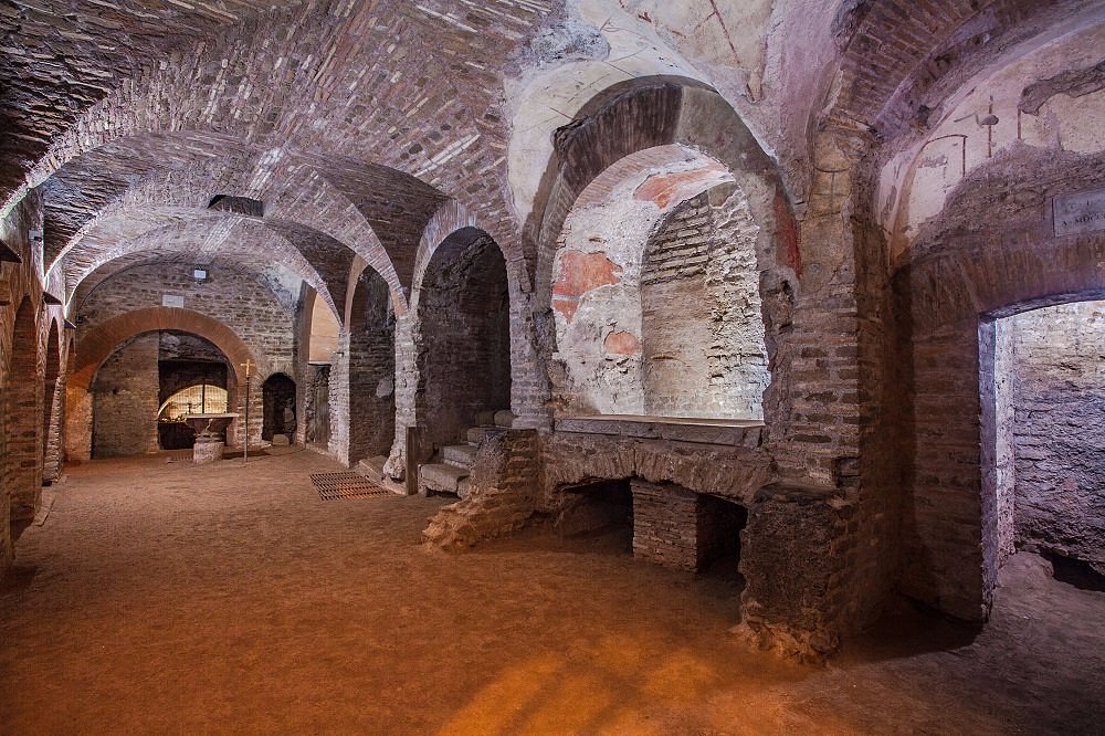 <ul><li><p><u><strong>Form and Function</strong></u></p><ul><li><p>Catacombs are passageways beneath Rome that extend for about 100 miles and contain the tombs of 4 million dead.</p></li><li><p>They contain the tombs of seven popes and many early Christian martyrs.</p></li><li><p>The Priscilla catacomb has some 40,000 burials.</p></li></ul></li><li><p><u><strong>Context</strong></u></p><ul><li><p>Called Priscilla because she was the donor of the land for her family’s burial. It was then opened up to Christians.</p></li><li><p><strong>Greek Chapel</strong></p><ul><li><p>Named for two Greek inscriptions painted on the right niche.</p></li><li><p>Three niches for sarcophagi.</p></li><li><p>Lower portions done in the first Pompeian style of painting with imitation marble paneling enriching the surface.</p></li><li><p>Upper portions decorated with paintings in later Pompeian styles: sketchy painterly brushstrokes.</p></li><li><p>Contains scenes of Old and New Testament stories.</p><ul><li><p>Old Testament scenes show martyrs sacrificing for their faith.</p></li><li><p>New Testament scenes show miracles of Jesus.</p></li></ul></li></ul></li><li><p><strong>Orant fresco</strong></p><ul><li><p>Fresco over a tomb niche set over an arched wall; cemetery of a family vault.</p></li><li><p>Central figure stands with arms outstretched in prayer; perhaps the same woman seen three times.</p><ul><li><p>Figure is compact, dark, and set off from a light background with terse angular contours and emphatic gestures.</p></li><li><p>Figure prays for salvation in heaven.</p></li><li><p>Deeply set eyes—windows to the soul—staring upward implore God’s deliverance.</p></li></ul></li><li><p><strong>Left</strong>: painting of a teacher with children, or the image of a couple being married with a bishop.</p><ul><li><p>At the right, mother and child, perhaps Mary with Christ or the Church.</p></li></ul></li></ul></li><li><p><strong>Good Shepherd fresco</strong></p><ul><li><p>Early Christian art often shows parallels between Old and New Testament stories, which Christians see as a fulfillment of the Hebrew scriptures and shows their interest in adapting them to their own context.</p></li><li><p>Restrained portrait of Christ as a Good Shepherd, a pastoral motif in ancient art going back to the Greeks.</p><ul><li><p>Symbolism of the Good Shepherd: rescues individual sinners in his flock who stray.</p></li></ul></li><li><p>Stories of the life of the Old Testament Prophet Jonah often appear in the lunettes; Jonah’s regurgitation from the mouth of a big fish is seen as prefiguring Christ’s ­resurrection.</p></li><li><p>Peacocks in lunettes symbolize eternal life; quails symbolize earthly life; Christ is seen as a bridge between these worlds.</p></li></ul></li></ul></li></ul>