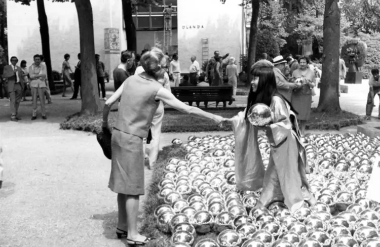 <ul><li><p><strong>ID:</strong> Yayoi Kusama, 1966 CE, Mirror balls, Performance art, Venice Biennale</p></li><li><p><strong>Content:</strong> Hundreds of reflective spheres arranged on the ground, interacting with viewers.</p></li><li><p><strong>Function:</strong> Critiques commercialization in the art world and self-obsession.</p></li><li><p><strong>Context:</strong> Kusama originally sold the balls herself at the Venice Biennale in a rebellious act.</p></li><li><p><strong>Form:</strong> Reflective surfaces, minimalistic repetition, audience participation.</p></li></ul><p></p>