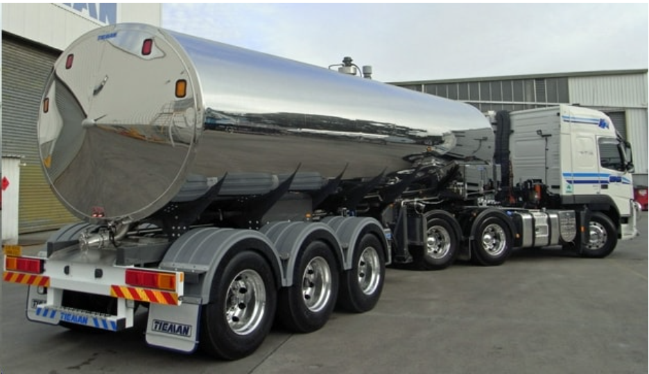 Which deformation process was most likely used to create the cylindrical tube of the tanker car pictured for hauling milk?