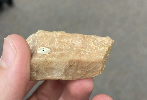 <p>Looks like sandstone, white flakes, With grain- smooth, against- rough, <strong>Ceramics</strong></p>
