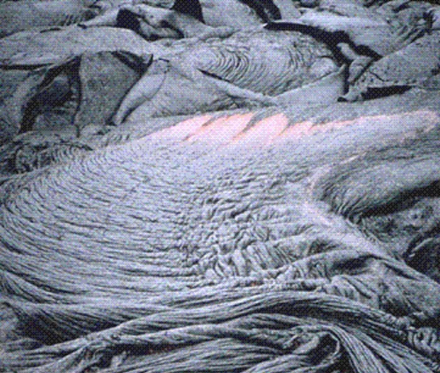 <p>less viscous, easier to move around. As it flows, the surface cools and starts to crystalize. The liquid underneath is still moving, so you end up with something that looks like braids of rope.</p>