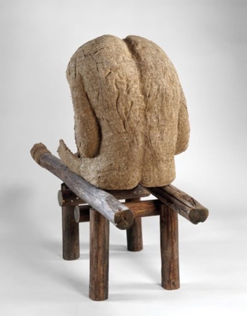 <p>Magdalena Abakanowicz</p><p>1985 CE</p><p>Form: Burlap, resin, wood, nails, and string</p><p>Function: Recall existential questions of life and death. Could be a man or women with a hollow body</p><p>She often sculpted the human form using the burlap cast with resin to harden it. Some of her figures sit alone while others are in groups, they often are without heads and sometimes without limbs. "Androgyne III" is one of her sculptural works, the headless, limbless figure sits hunched over on a stretcher made of wood, the title implies that this could be a man or woman, the body of the figure is hollow and empty. The sculptures of Magdalena Abakanowicz recall existential questions of life and death, as well as the theme of the individual versus the collective identity.</p>