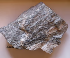 <p>micas are the dominant minerals. finely foliated (layered), cleaves easily along foliation to form rough surface with visible mica flakes.</p>