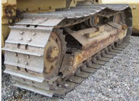 <p><strong>on large vehicle.</strong><span>a continuous belt of metal plates around the wheels of a large vehicle such as a bulldozer that allows it to move over the ground</span></p>