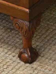 <p>Variety of ball and claw topped by and thus attached to body of a piece by brackets</p>