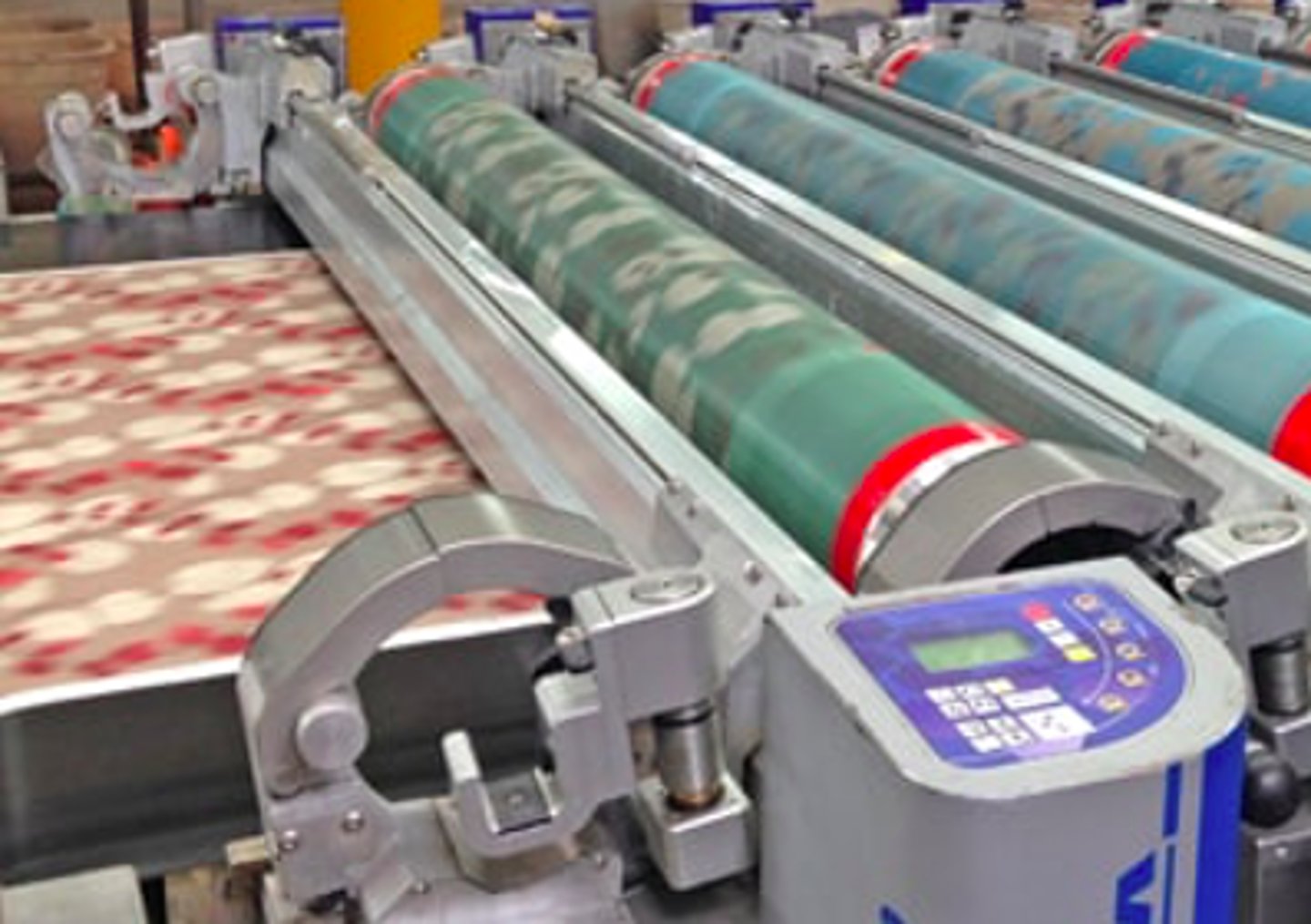 <p>a method of printing textiles that uses a series of engraved metal rollers each of which contains the parts of the pattern to be printed in one color.</p>