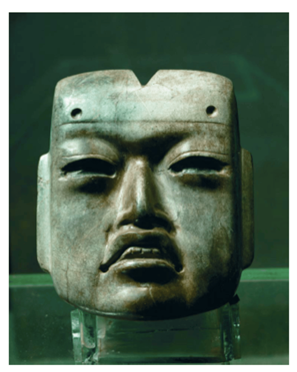 <p>Tenochtitlan (modern Mexico City, Mexico)</p><p>Mexica (Aztec)</p><p>1375-1520 CE</p><p>Form: Jadeite</p><p>Carved from a green stone, similar to jadeite, the mask is only about the size of your palm. It is curved with the typical Olmec features of heavy lilted eyes, a frown on the mouth and almost baby-like face</p>