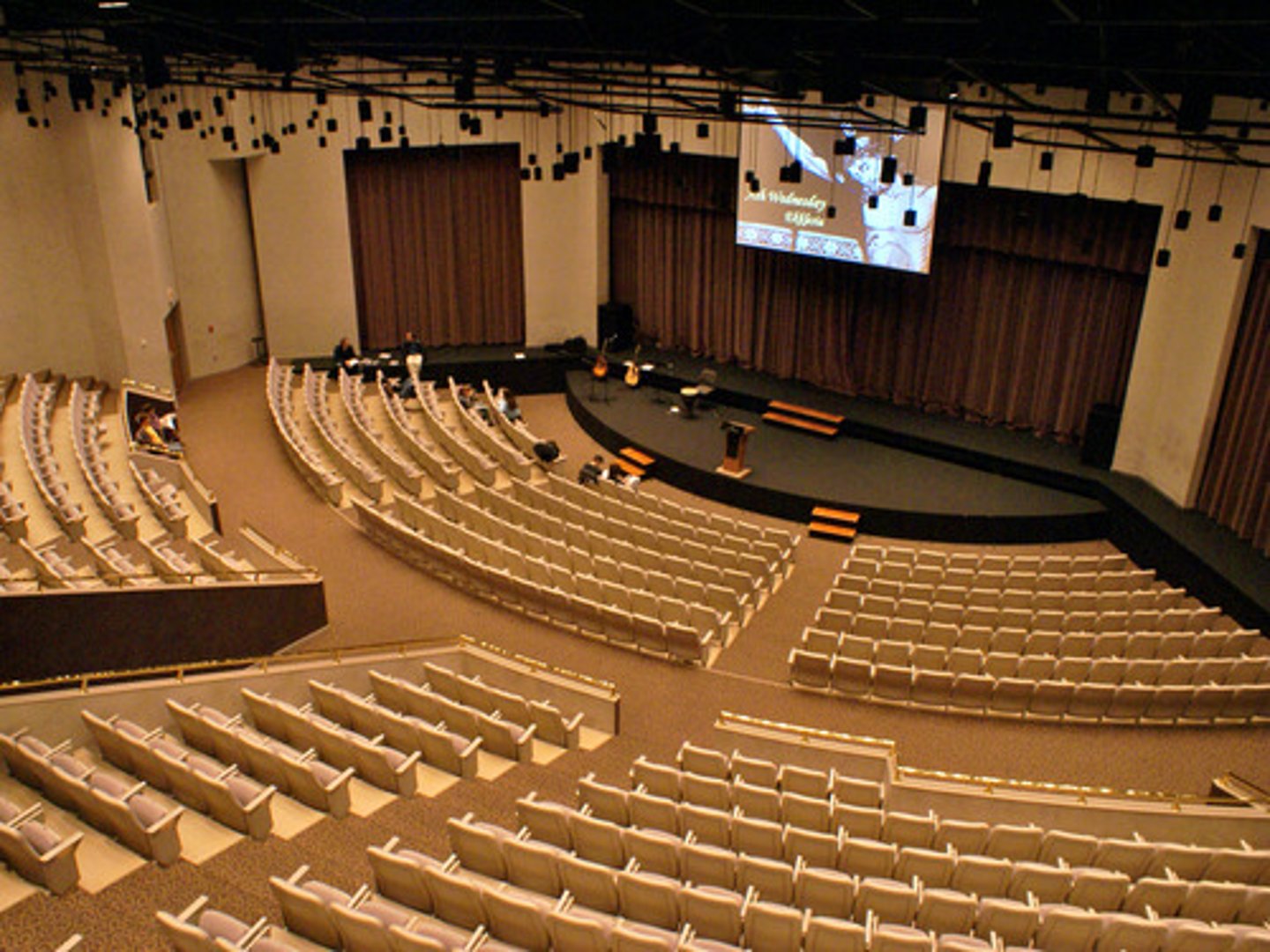 <p>A large room where people gather to hear a speaker</p>