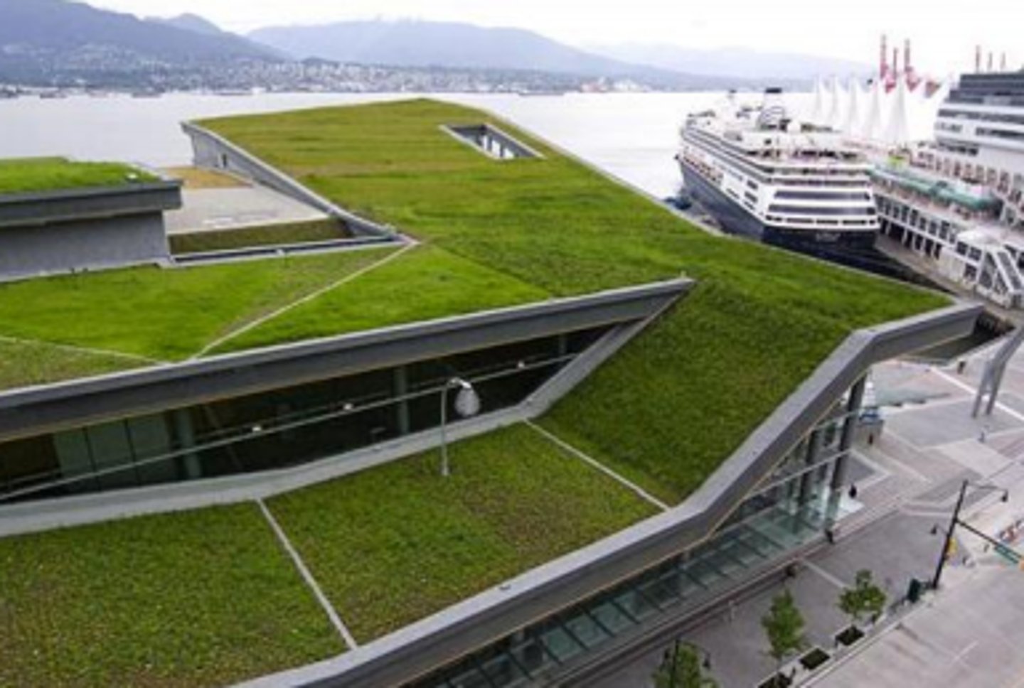 <p>a roof of a building that is partially or completely covered with vegetation, a growing medium, and sometimes a root layer and drainage system, installed over a waterproof membrane to lower building temperatures, reduce the heat island effect, lessen stormwater runoff, and absorb carbon dioxide from the air</p>