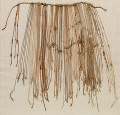 <p>An intricate system of knotted and colored strings used by early South American cultures (Inca) to store information such as census and tax records</p>