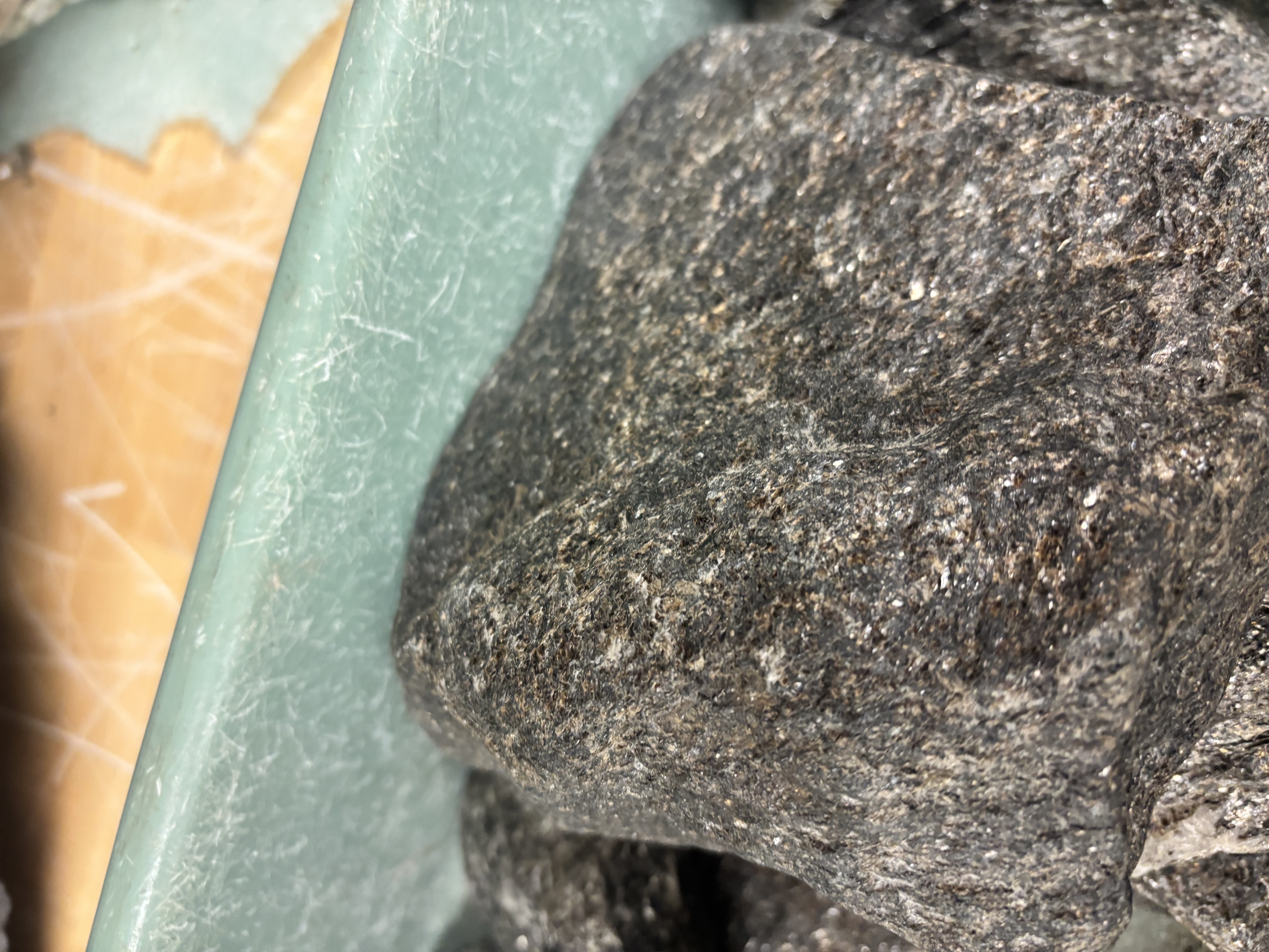 <p>Foliated metamorphic rock with visible mica or other platy minerals; medium to high grade.</p>