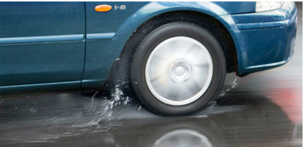 The speed limit posted on a road is 55 mph. When this road is wet:
