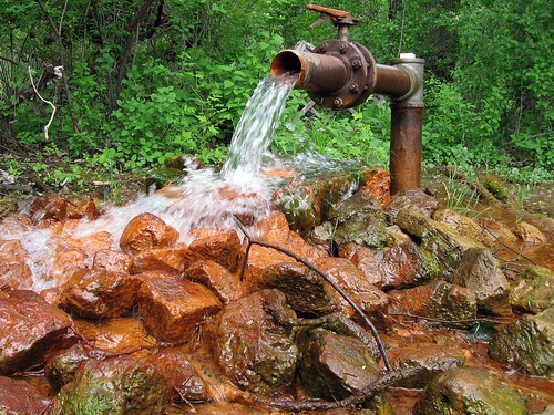 A well in which water rises because of pressure within the aquifer