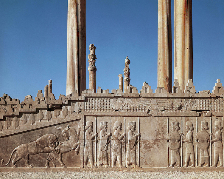 <p>Audience Hall of Darius and Xerxes</p><ul><li><p>Persepolis, Iran</p></li><li><p>Persian.</p></li><li><p>c. 520-465 B.C.E.</p></li><li><p>Limestone</p></li></ul><p>It was the largest building of the complex, supported by numerous columns and lined on three sides with open porches. The palace had a grand hall in the shape of a square, each side 60m long with seventy-two columns, thirteen of which still stand on the enormous platform. Relief artwork, originally painted and sometimes gilded, covered the walls of the Apadana depicting warriors defending the palace complex.</p>