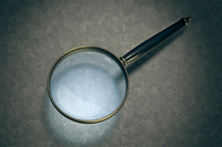 <p>a convex lens mounted in a frame that enlarges the appearance of objects. Often used for detailed examination of text or small items. </p>