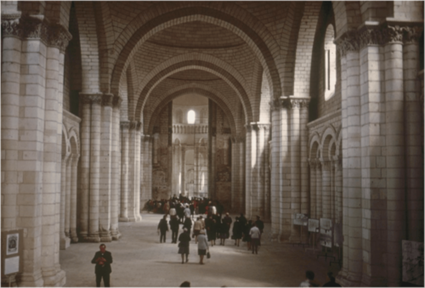 <p>Large barrel vaults, tall cylindrical piers, and pointed transverse arches</p>