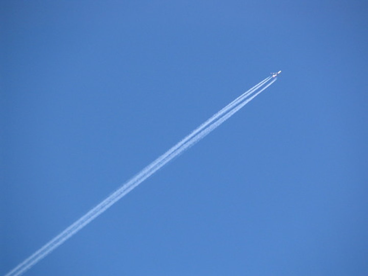 <p>condensation trails left behind jet aircrafts. Contrails form when hot humid air from jet exhaust mixes with environmental air of low vapor pressure and low temperature. The mixing is a result of turbulence generated by the engine exhaust.</p>
