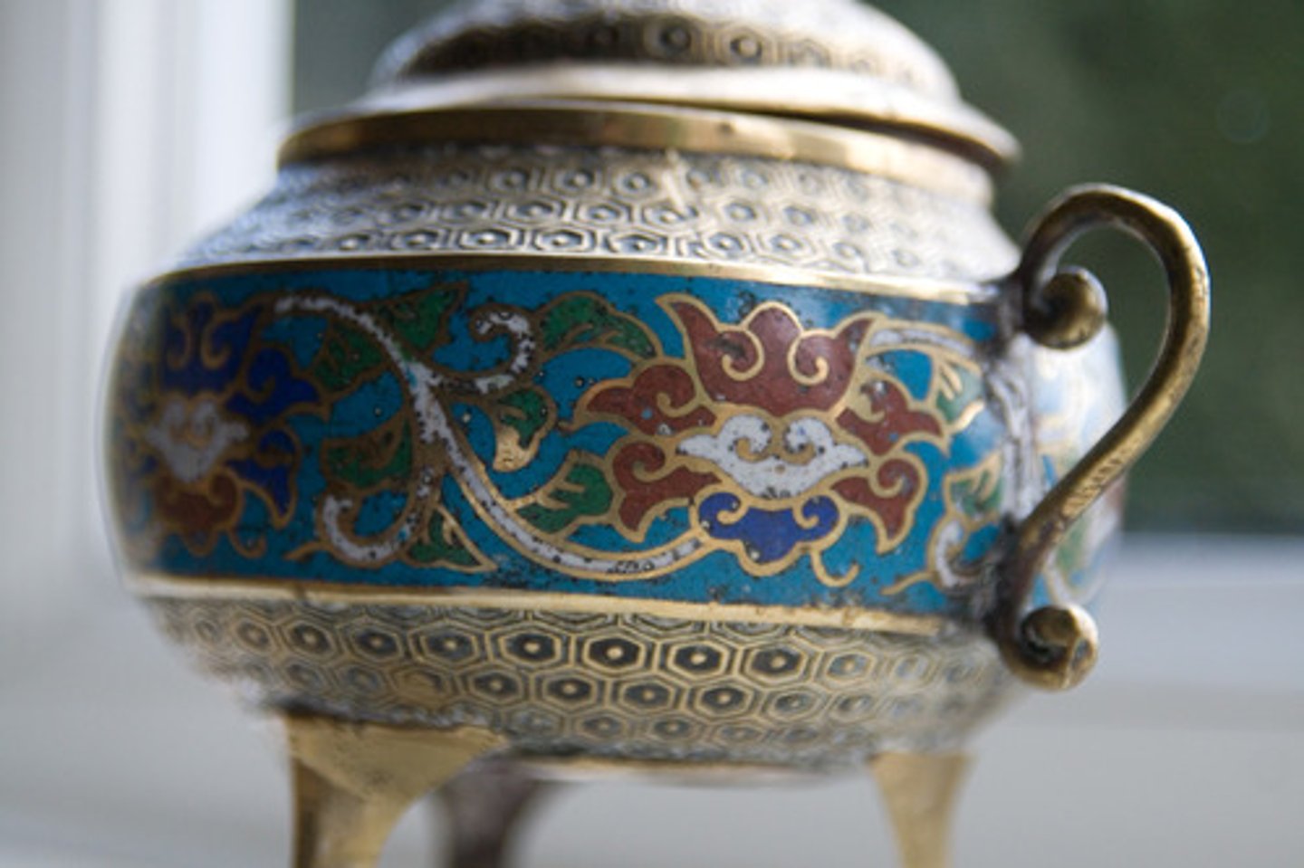 <p>A metalwork technique in which wires are soldered onto a metal surface to form compartments(cloisons). The compartments are filled with enamel or cut gemstones.</p>