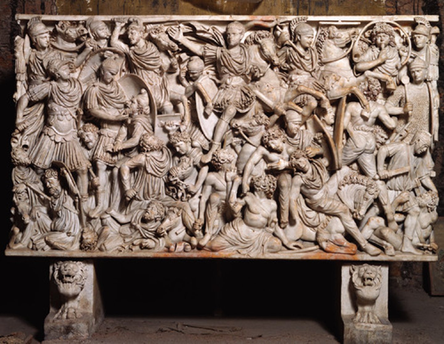 <p>Form:</p><p>-marble</p><p>-high relief</p><p>Content:</p><p>-figures piled on top of each other, crowded surface</p><p>-Romans shown as the good guys (ideal/noble)</p><p>-Romans trampling over defeated barbarians</p><p>- enemies very caricatured with great detail</p><p>Function:</p><p>-tomb</p><p>Context:</p><p>-late imperial empire; 250 CE</p>