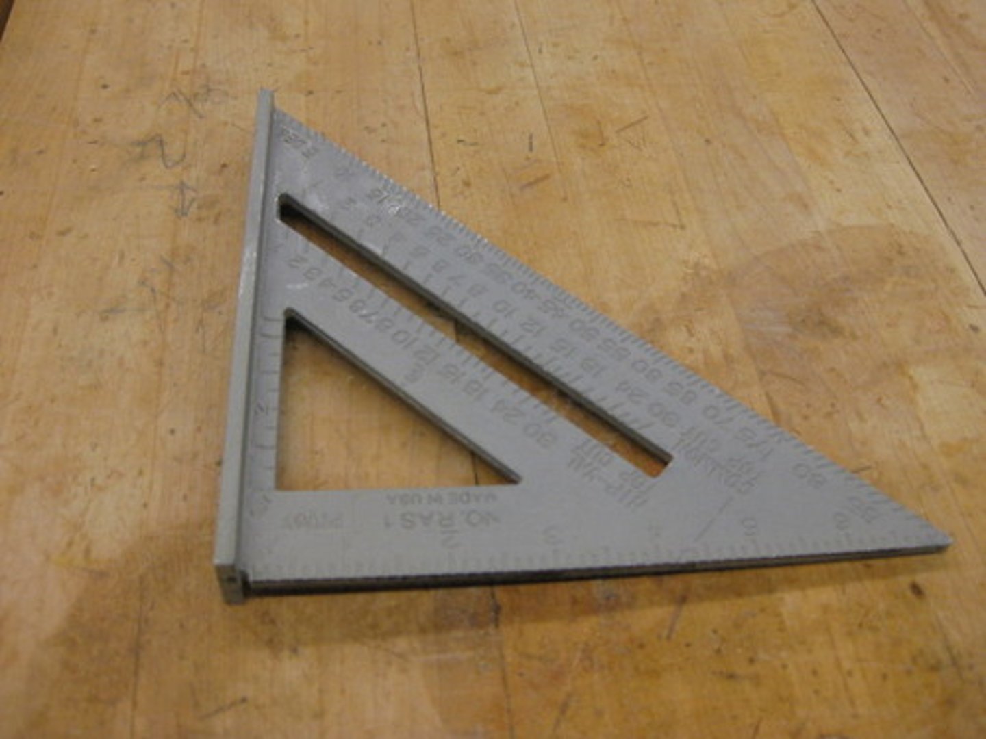 <p>A trianglular marking tool containing both 90 and 45 degree angles. It has a flange on one side so you can "square" it against the material.</p>