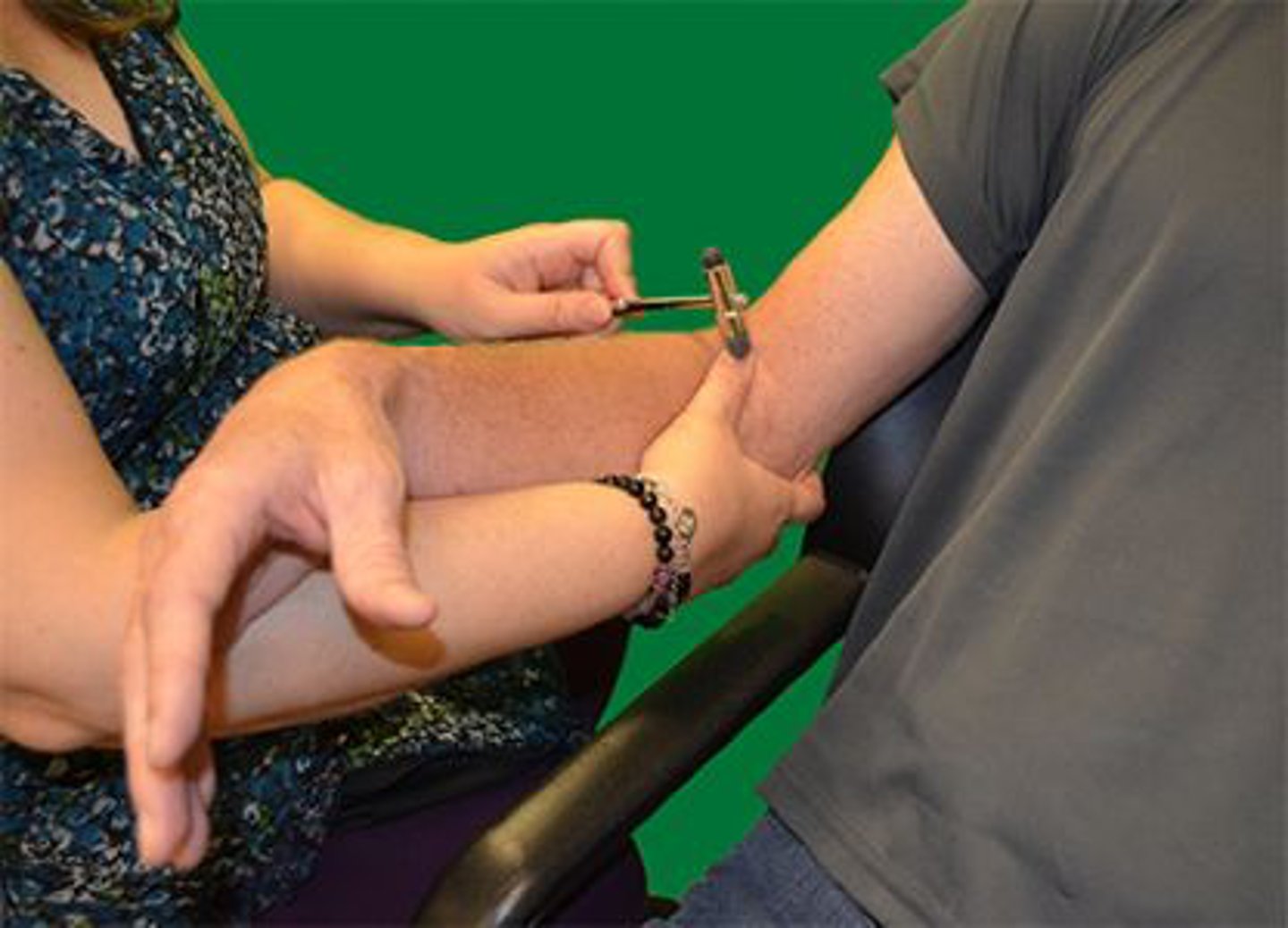 <p>Which of the following nerves innervates the muscle reflex being tested in the photograph?</p><p>1. Musculocutaneous</p><p>2. Radial</p><p>3. Axillary</p><p>4. Median</p>