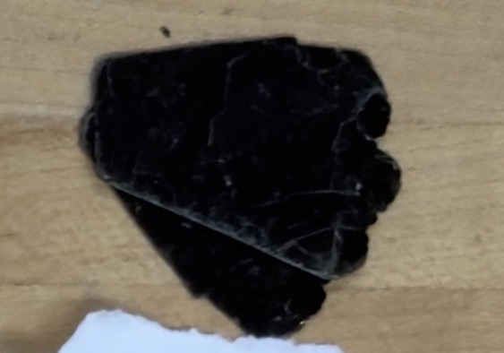 <p>Black, thin sheets, plasticy</p>