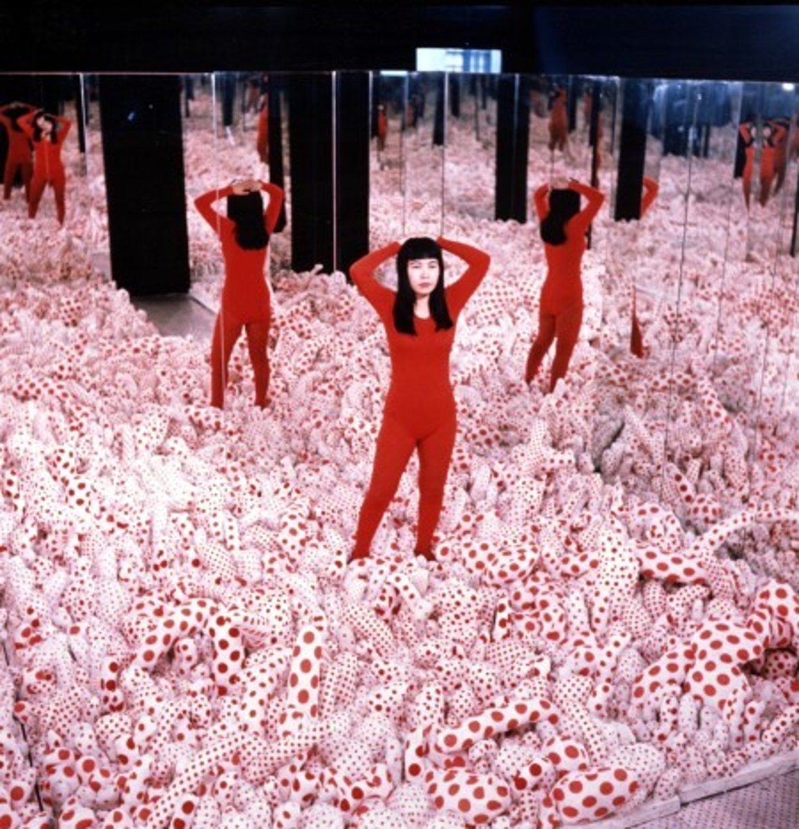 <p>a groundbreaking, immersive installation utilizing mirrors and hundreds of red-spotted, white-stuffed fabric protrusions to create an endless, hypnotic landscape. It represents Kusama's "obsessional art," blending themes of sexual liberation, phobias, and self-obliteration. This piece revolutionized art by transforming viewers into participants within a "machine for animation," casting their reflections into an infinite,,,psychedelic space</p>