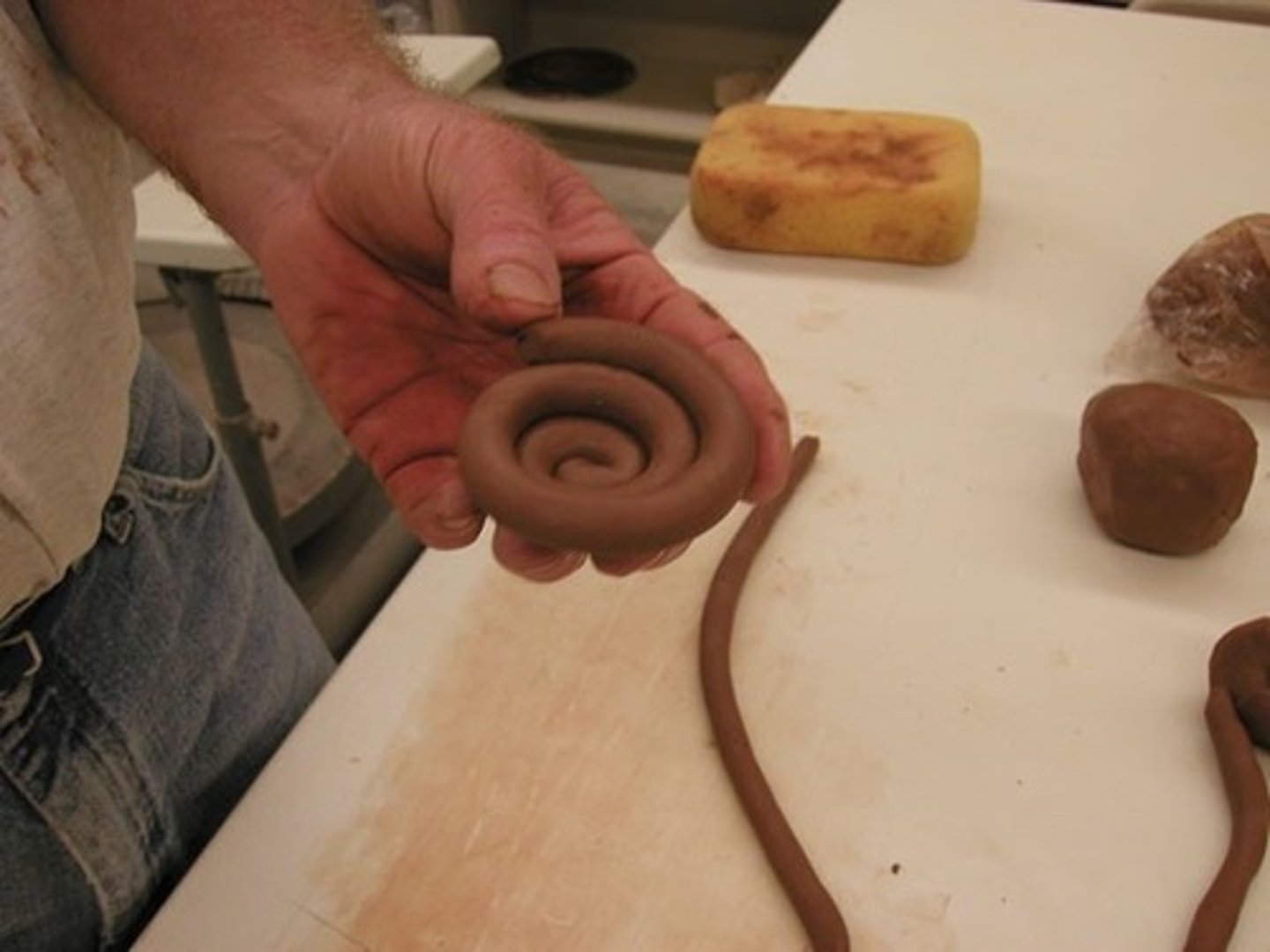 <p>method of pottery building using long snake like pieces of clay. Then coiled on top of one another scoring and using slip in-between</p>